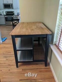 Butcher block table with stainless steel shelves and seating for 2